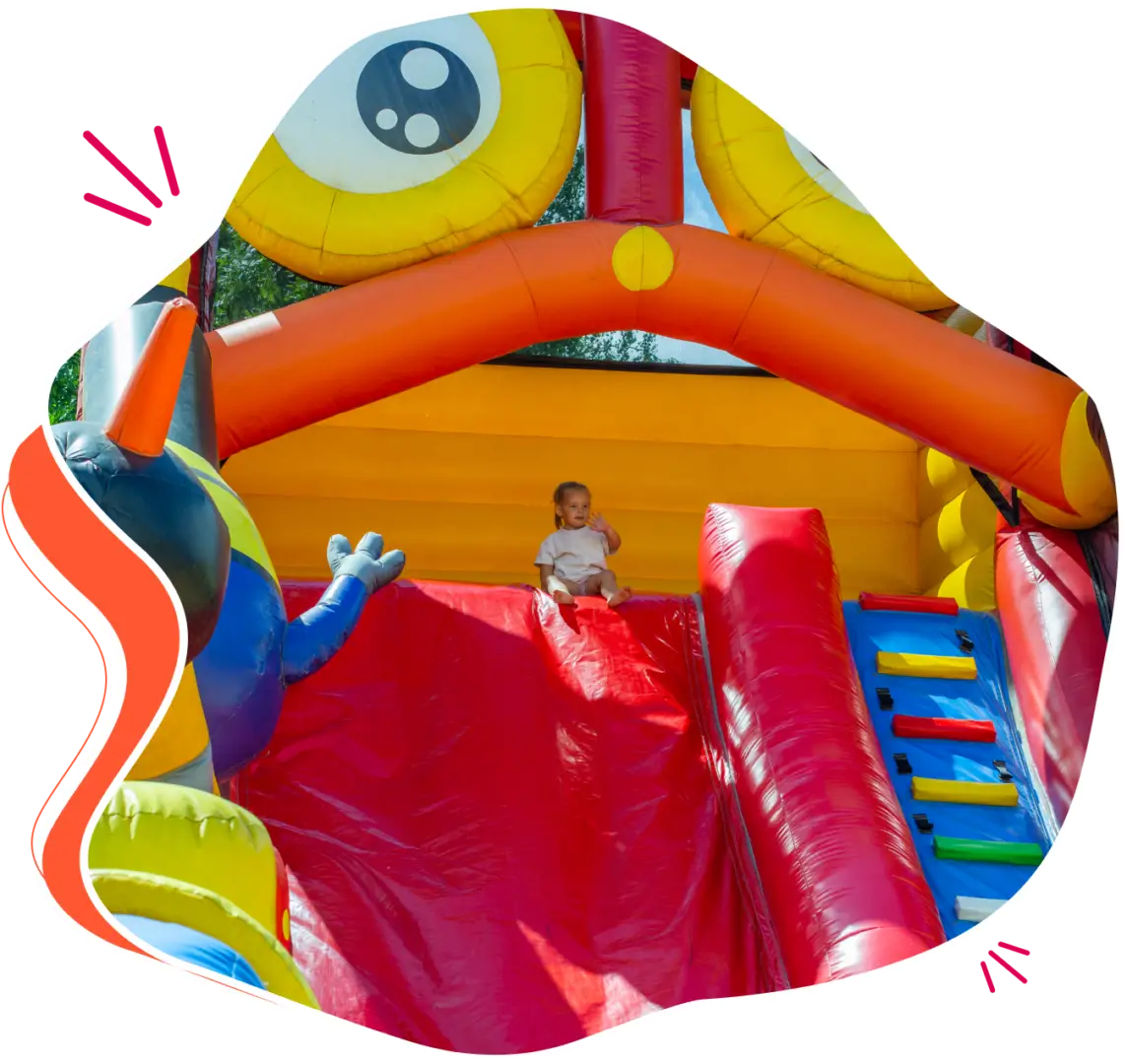 Toddler playing on inflatable bounce house.