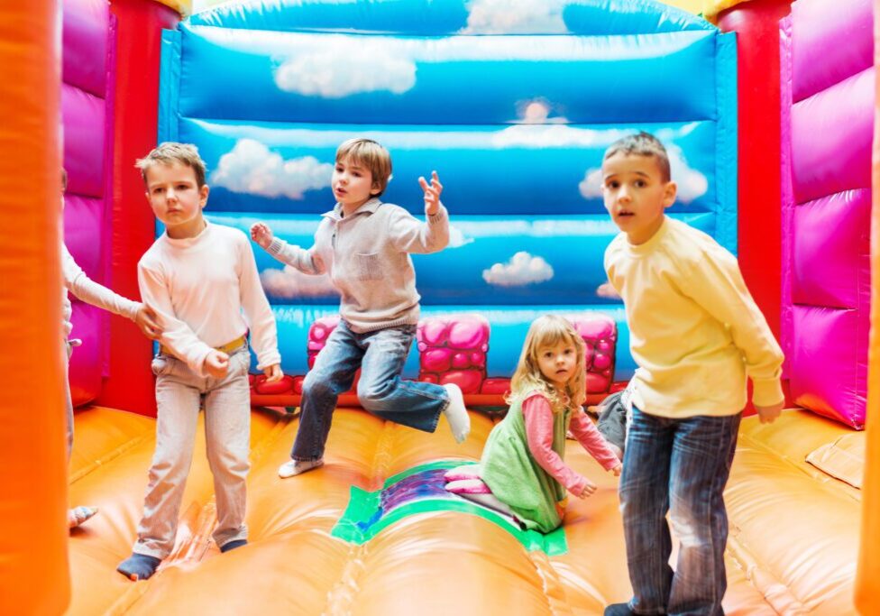 Kids playing in inflatable bounce house.